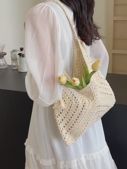 Video preview of a cream chevron crochet shoulder bag worn with a light dress 
